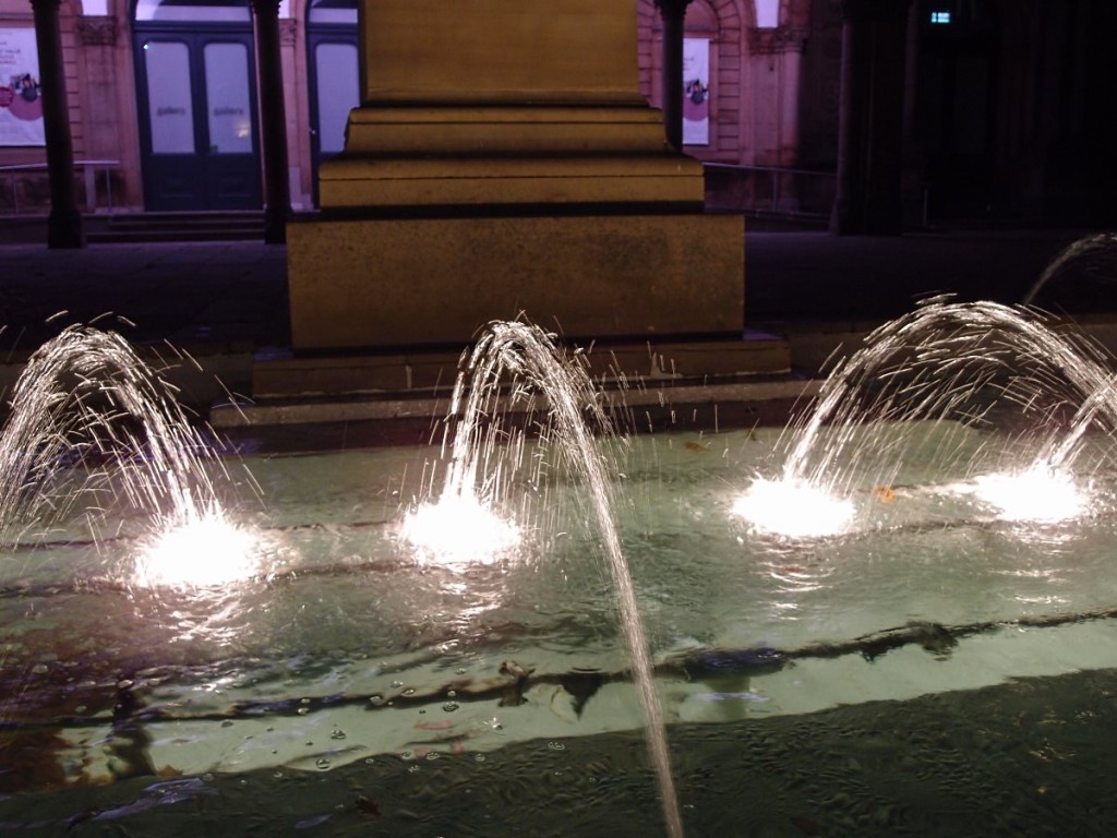 Fountain jets, lit up, in dark